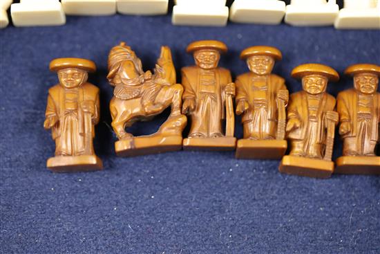 An unusual late 19th century Japanese brown stained and natural ivory figural chess set, kings 1.75in.